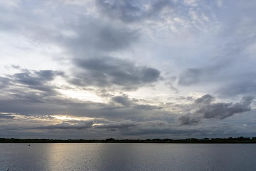 The clouds filled the sky, obscuring the light from the sun during the sunset.