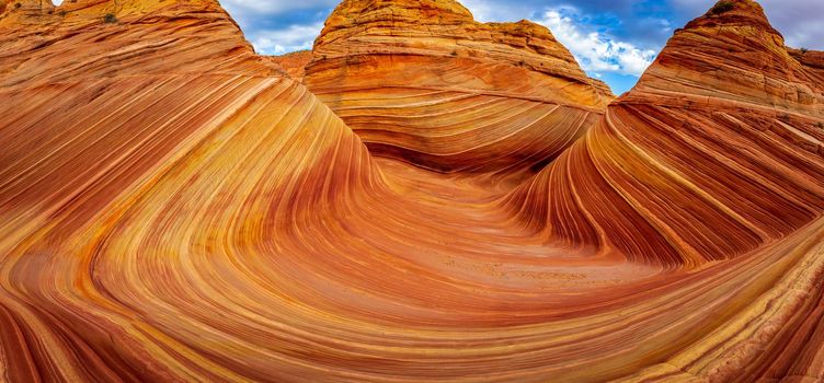 The Wave is a famous sandstone rock formation located in Coyote Buttes, Arizona, known for its colorful, undulating forms