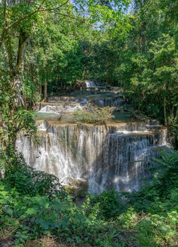 Many waterfalls flow in the frame of plants and green trees. Huai Mae Kamin Waterfall Viewpoint, Kanchanaburi Province