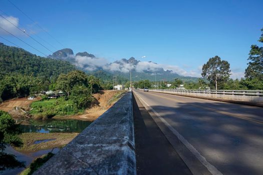 The destination of the road is a foggy mountain road to Pilok Village, Kanchanaburi Province, Thailand.