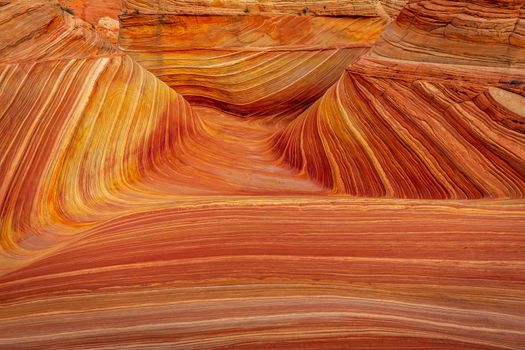 The Wave is a famous sandstone rock formation located in Coyote Buttes, Arizona, known for its colorful, undulating forms