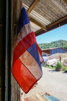 Thailand flag Hang in front of the house. E-Tong Village, Pilok Mine, Kanchanaburi, Thailand in the afternoon - 12 November 2016