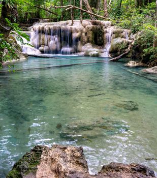 Clean green emerald water from the waterfall Surrounded by small trees - large trees,  green colour, Erawan waterfall, Kanchanaburi province, Thailand