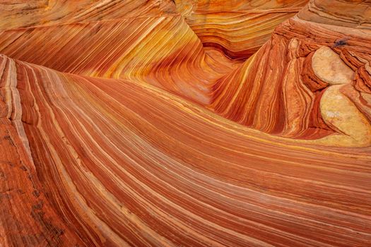 The Wave is a famous sandstone rock formation located in Coyote Buttes, Arizona, known for its colorful, undulating forms