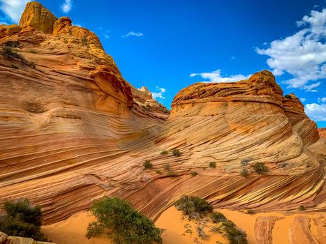 The Wave is a famous sandstone rock formation located in Coyote Buttes, Arizona, known for its colorful, undulating forms