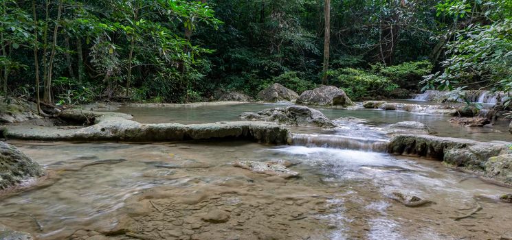 Clean green emerald water from the waterfall Surrounded by small trees - large trees,  green colour, Erawan waterfall, Kanchanaburi province, Thailand