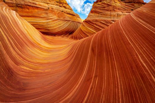 The Wave is a famous sandstone rock formation located in Coyote Buttes, Arizona, known for its colorful, undulating forms