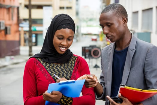 young business people standing in the street working with a smile.