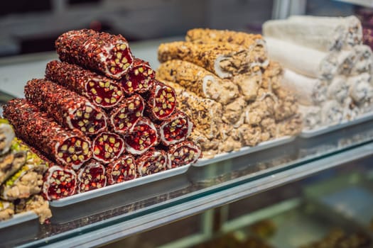 Traditional oriental sweet pastry cookies, nuts, dried fruits, pastilles, marmalade, Turkish desert with sugar, honey and pistachio, in display at a street food market.