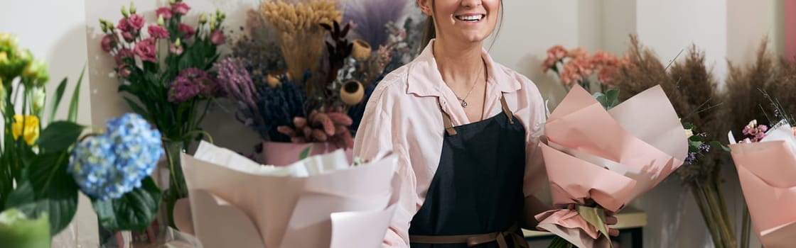 happy professional woman is working in flower shop