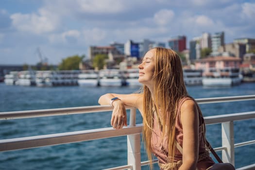 Happy woman enjoying the sea from ferry boat crossing Bosphorus in Istanbul. Summer trip to Istanbul.