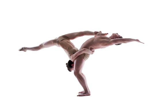 Attractive young gymnasts show acrobatics, isolated on white