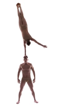 Sporty couple showing acrobatic support, isolated on white
