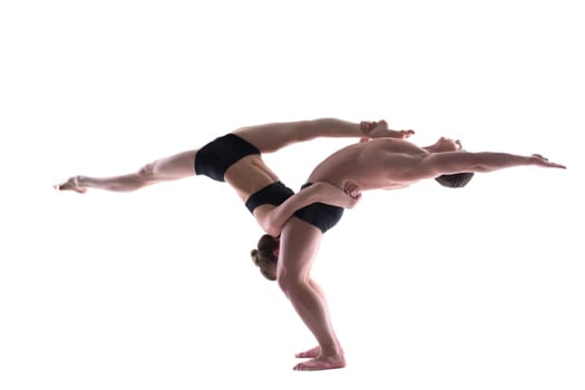 Young graceful gymnasts posing in studio, isolated on white