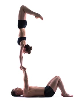 Image of young flexible people showing acrobatics, isolated on white