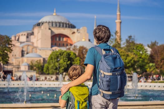Father and son Tourists enjoy beautiful view on Hagia Sophia Cathedral, famous islamic Landmark mosque, Travel to Istanbul, Turkey. Traveling with kids concept. Sunny day architecture and Hagia Sophia Museum, in Eminonu, istanbul, Turkey. Turkiye.