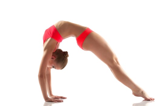 Slim flexible woman doing gymnastics bridge, isolated on white