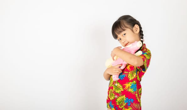 Happy Songkran Day, Asian kid girl with floral shirt hold water gun, Thai child funny hold toy water pistol and smile, isolated on white background, Thailand Songkran festival national culture concept