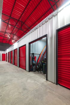 Corridor of self storage unit with red doors. Rental Storage Units