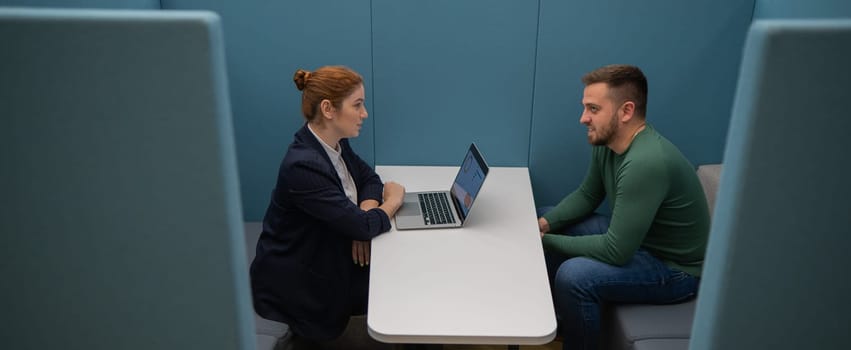 Caucasian woman and bearded man at the talks in the room. Job interview