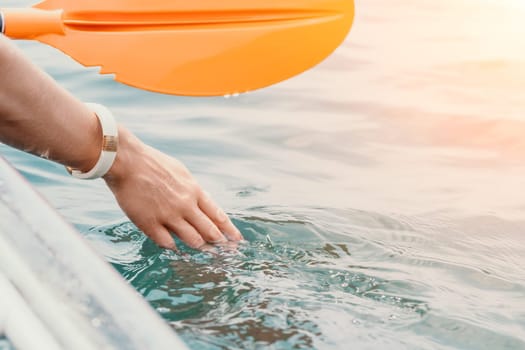 Woman in kayak back view. Happy young woman with long hair floating in transparent kayak on the crystal clear sea. Summer holiday vacation and cheerful female people having fun on the boat.