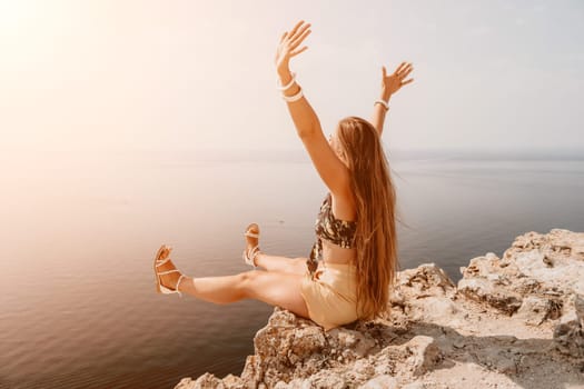 Woman travel sea. Happy tourist taking picture outdoors for memories. Woman traveler looks at the edge of the cliff on the sea bay of mountains, sharing travel adventure journey.