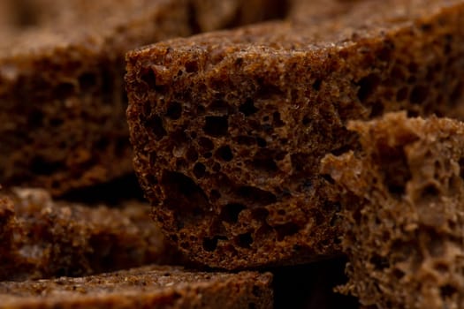 Rye croutons close-up view, dark bread texture, macro photography