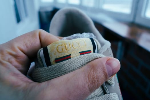 Tyumen, Russia-February 23, 2023: Gucci sneaker, stylish fashionable Logo close-up