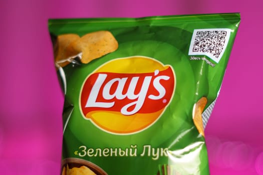 Tyumen, Russia-January 06, 2023: Lays potato chips bar, onion flavored, green packaging. Popular brand of potato chips