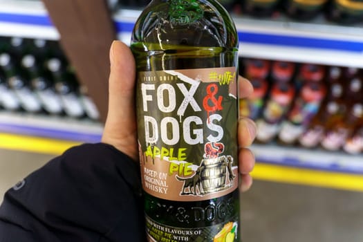 Tyumen, Russia-March 17, 2023: Fox and Dogs apple pie is a classic Scotch whiskey, on the shelves of a hypermarket.