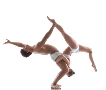 Two flexible acrobats posing in studio, isolated on white