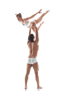 Muscular man holds young slim woman, isolated on white