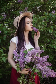 A fashionable girl with dark hair, a spring portrait in lilac tones in summer. Bright professional makeup