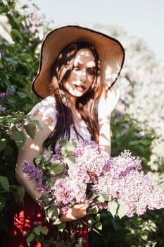 A fashionable girl with dark hair, a spring portrait in lilac tones in summer. Bright professional makeup