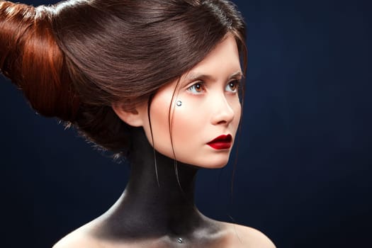Beautiful girl with a haird in the form of horns. Ads for hairdressers.