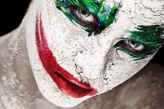 Horror portrait of a girl with an creative make-up in joker style