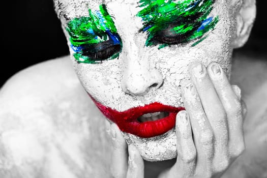 Horror portrait of a girl with an creative make-up in joker style