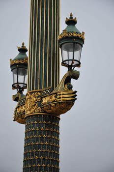 Vertical shot of a Historic street light with gold and gas lamps in Paris, France