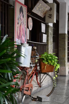 Red bicycle with a flower pot in front of Hayashi Department Store in Tainan, Taiwan