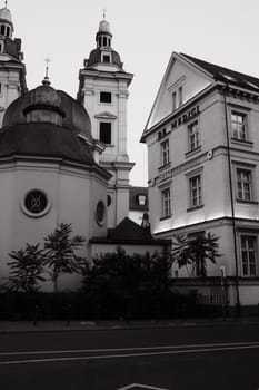 Vertical grayscale shot of St. Andreas Monastery Church and Hotel de Medici in Duesseldorf, Germany
