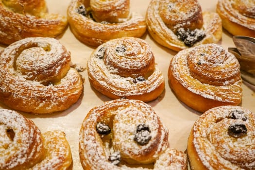 Croisants and cinnamon ro;;s in a display shelf for breakfast