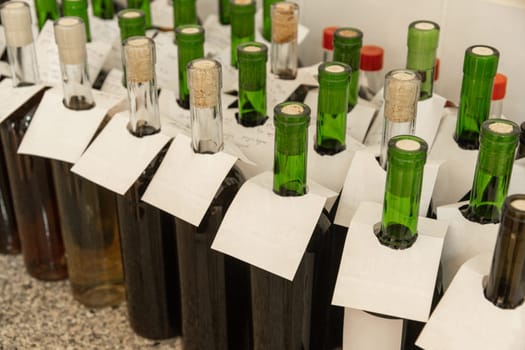 A closeup of bottles of wine. Concept of winemaking, quality control