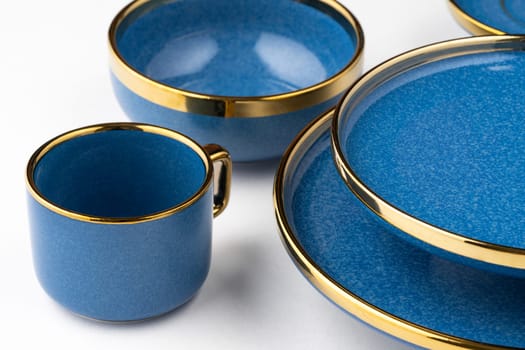 A set of blue ceramic plates and cup on a white background