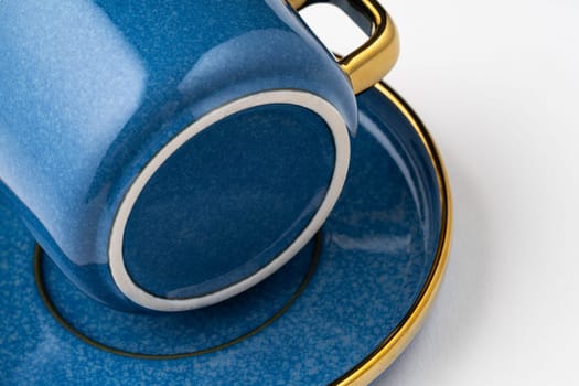 A set of blue ceramic plates and cup on a white background