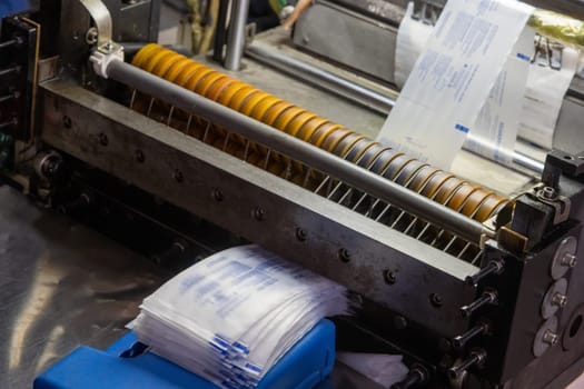 A closeup shot of a machine printing syringe labels at a medical production warehouse