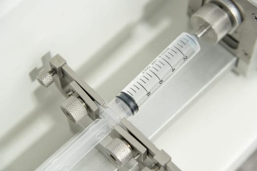 A closeup of the production and testing of medical syringes and droppers