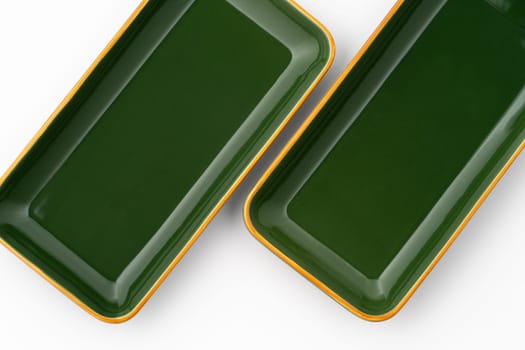 A set of green ceramic plates on a white background