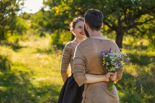 man giving wild flowers to his girlfriend