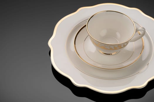 A luxury tableware set on black reflective surface