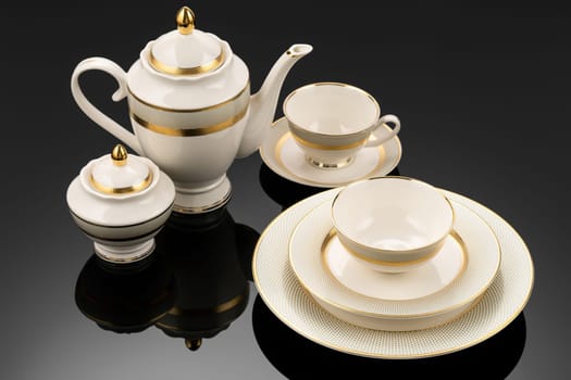 A luxury tableware set on black reflective surface